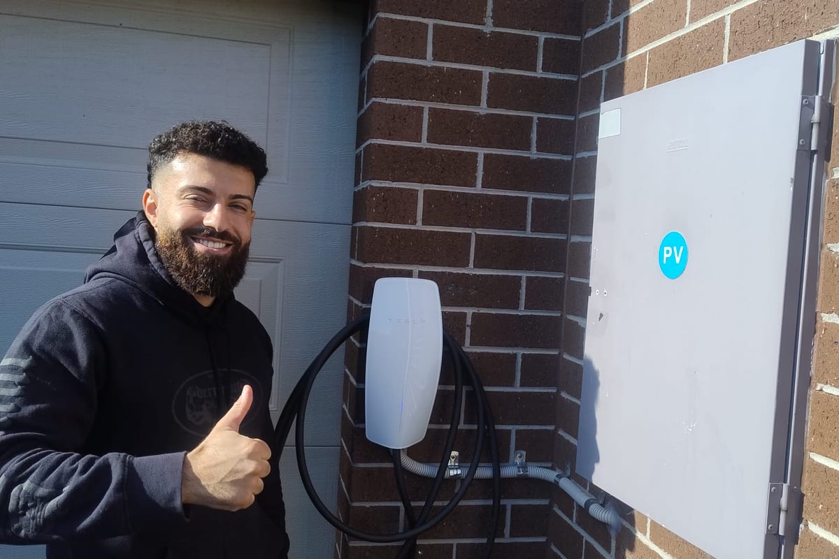 Lion Heart Electrical electrician beside a newly installed home EV charger in Melbourne